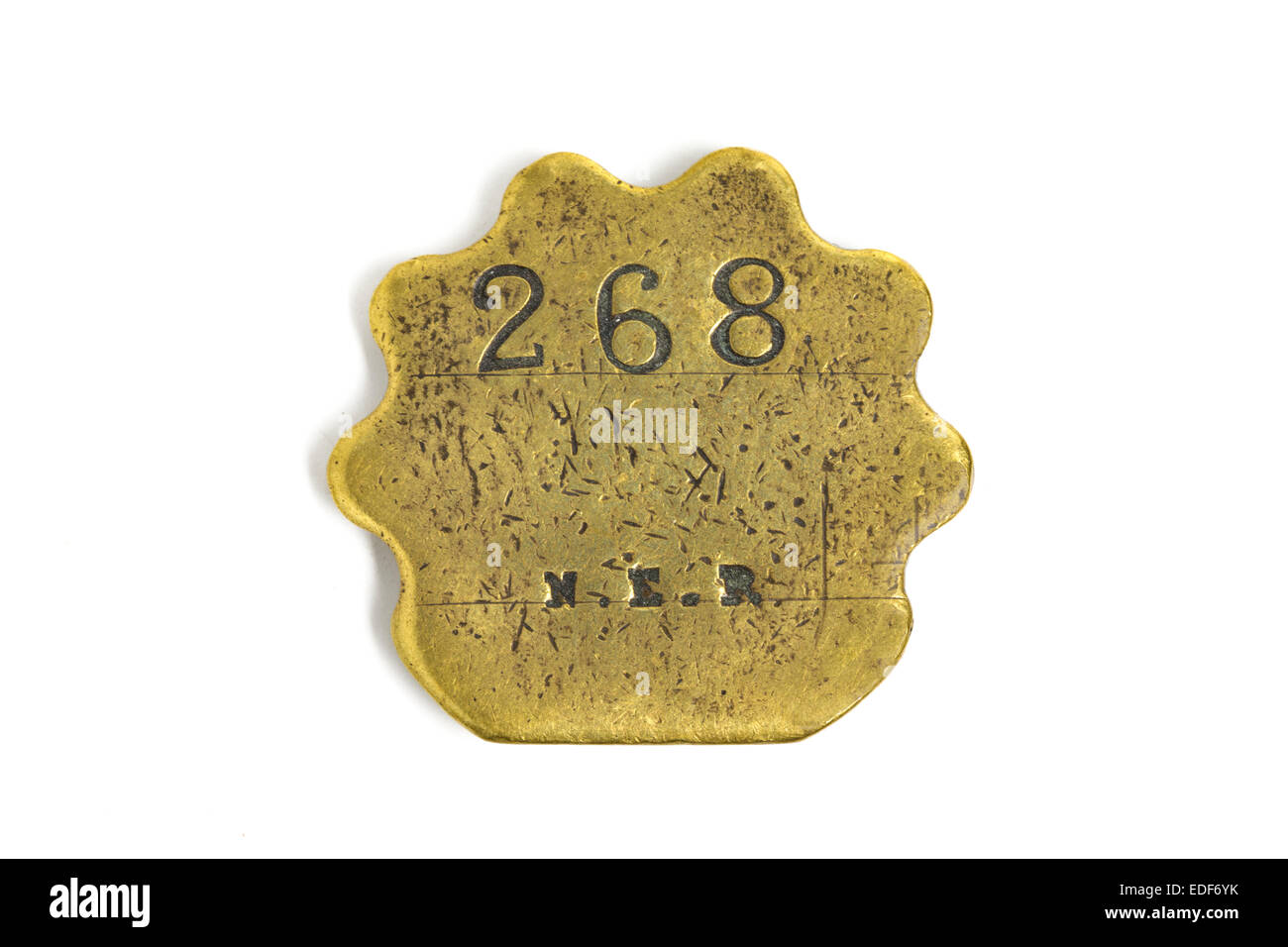 Brass pay token, or tally, issued by North Eastern Railway (NER) before grouping in 1923. Stock Photo