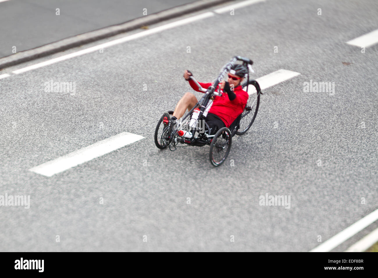 handicaped Man on bike during an iron man competition in Denmark Stock Photo