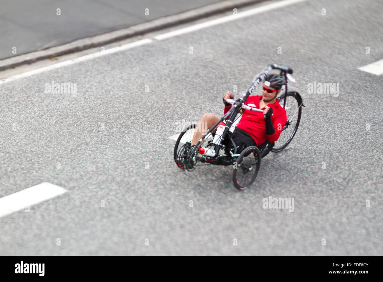 Handicaped Man on bike during an iron man competition in Denmark Stock Photo