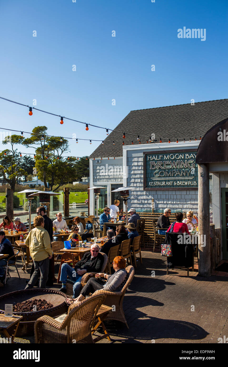 Half Moon Bay Brewing Company in Half Moon Bay, California is busy on the patio on a sunny day. Stock Photo