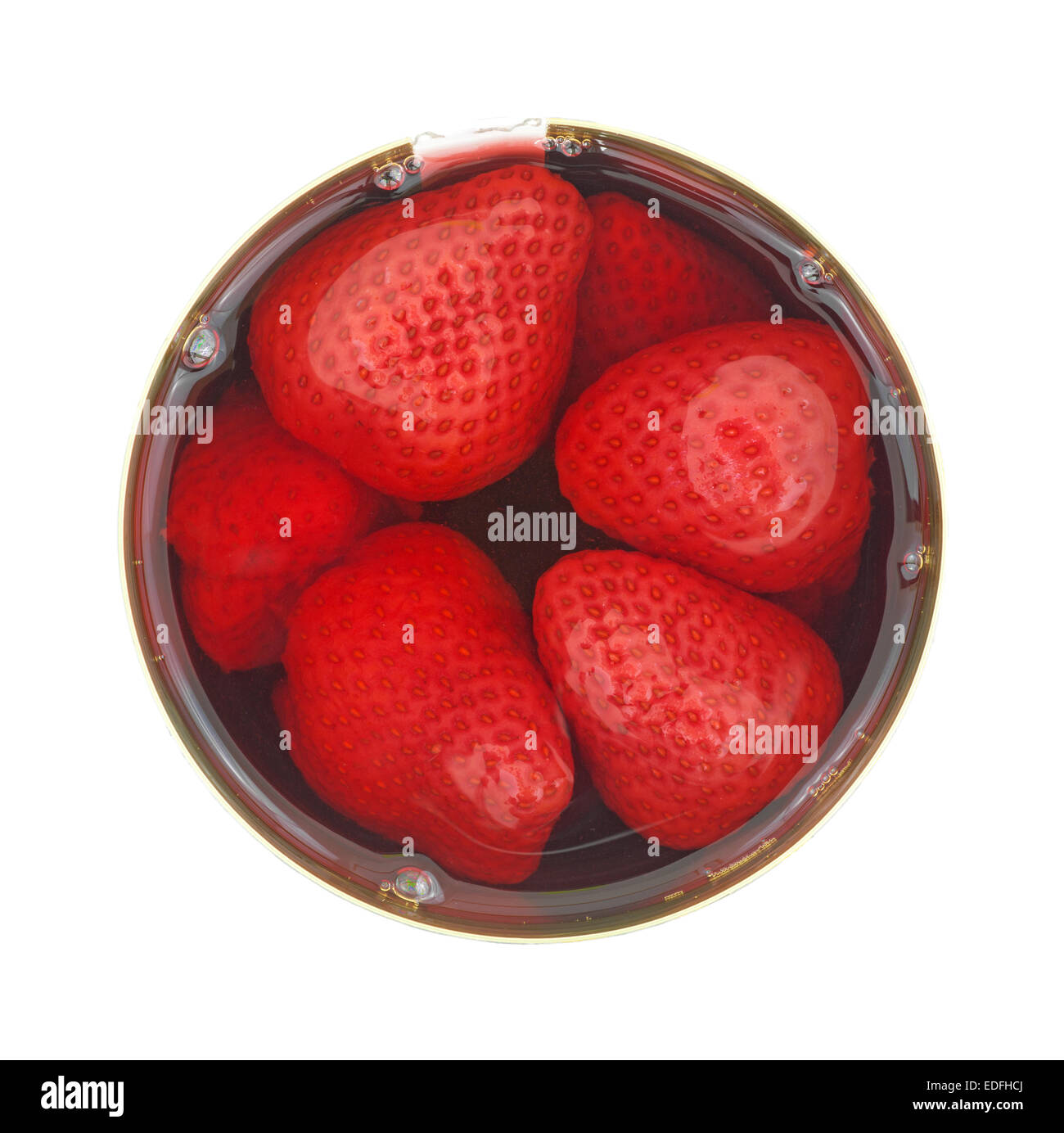 Top view of an opened tin of canned strawberries in liquid on a white background. Stock Photo