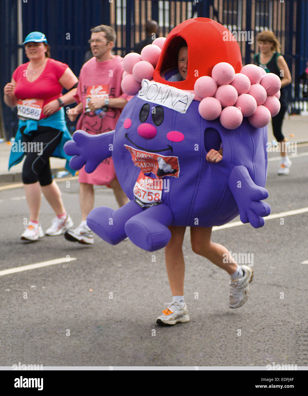 A runner in the London Marathon has made life difficult for herself by wearing a very unwieldy costume. Stock Photo