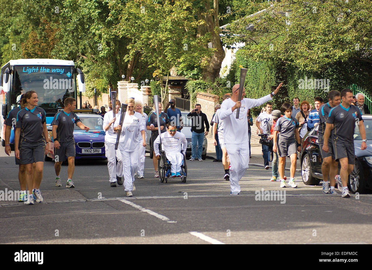 The London Paralympic Torch Relay passes through St. John's Wood on its way to the famous zebra crossing in Abbey Road. Stock Photo
