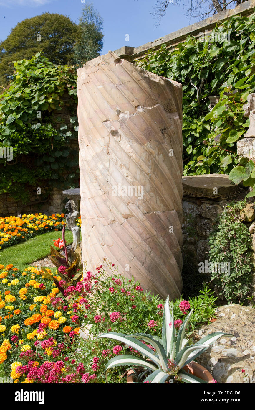 Flowers and stone statue in Hever Castle garden, Kent, England Stock