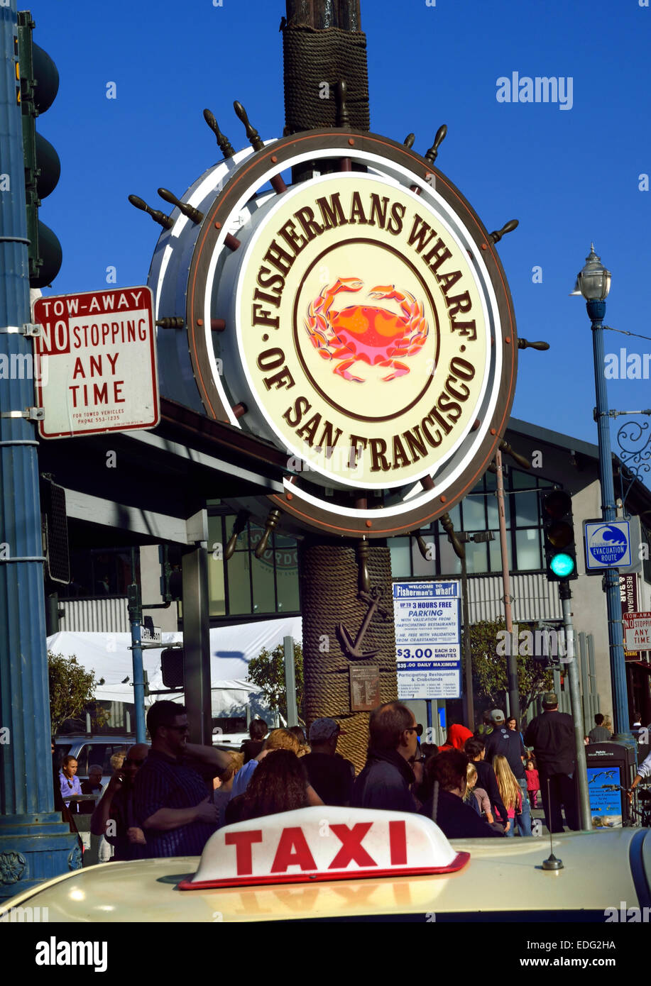 Sign at busy entrance to the Fisherman's Wharf with Taxi sign in foreground Embarcadero San Francisco California USA Stock Photo