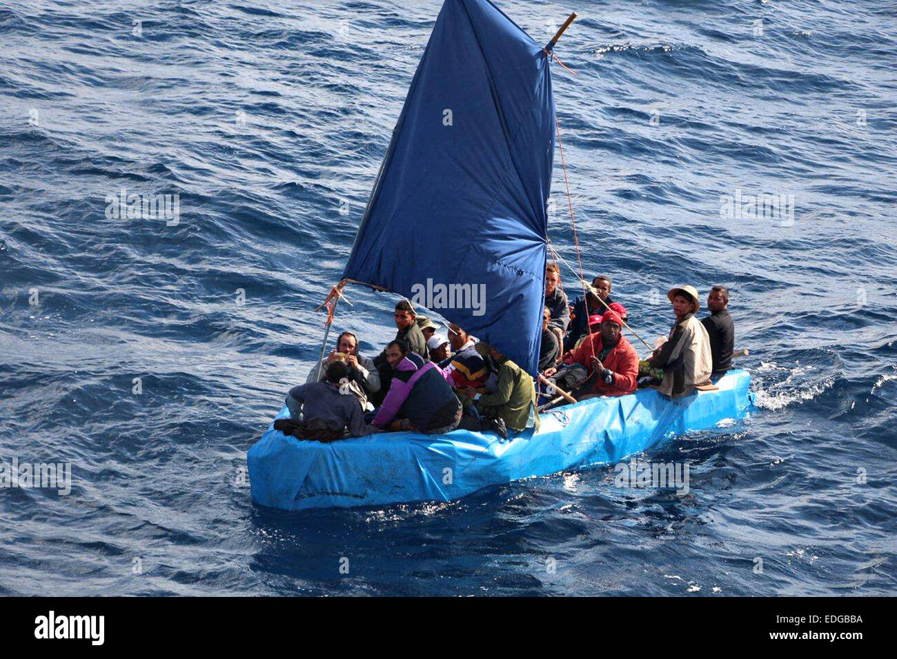 A makeshift boat carrying 24 Cuban migrants is intercepted by the US Coast Guard January 1, 2014 of Key West, Florida. The US Coast Guard reports that the number of Cubans picked up at sea trying to reach the United States has surged since President Barack Obama announced plans to restore diplomatic relations with Havana. Stock Photo