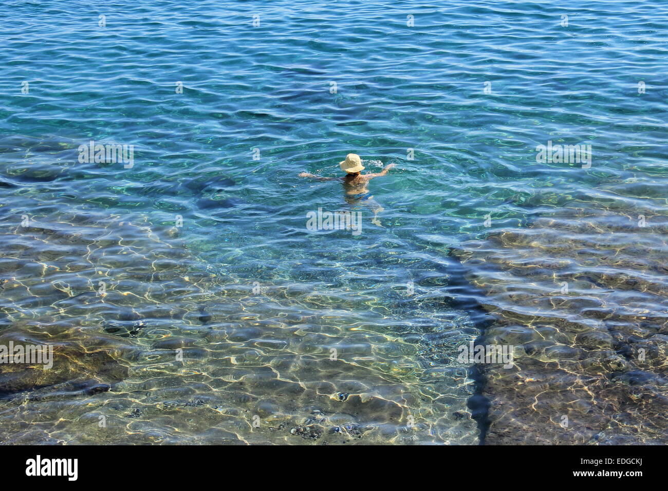 Lady swimming in Taormina, Sicily, Italy Stock Photo