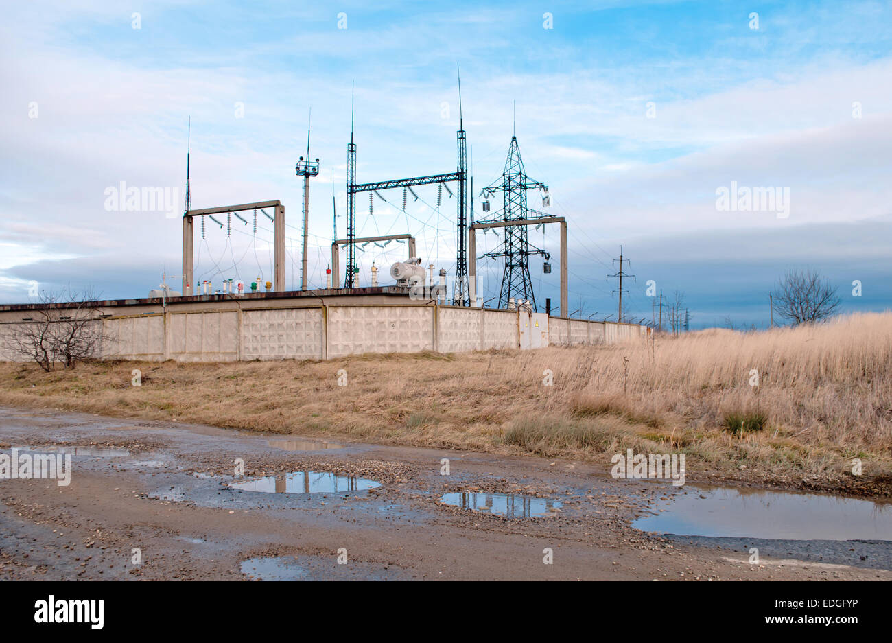 substation with plowed field on sky background Stock Photo