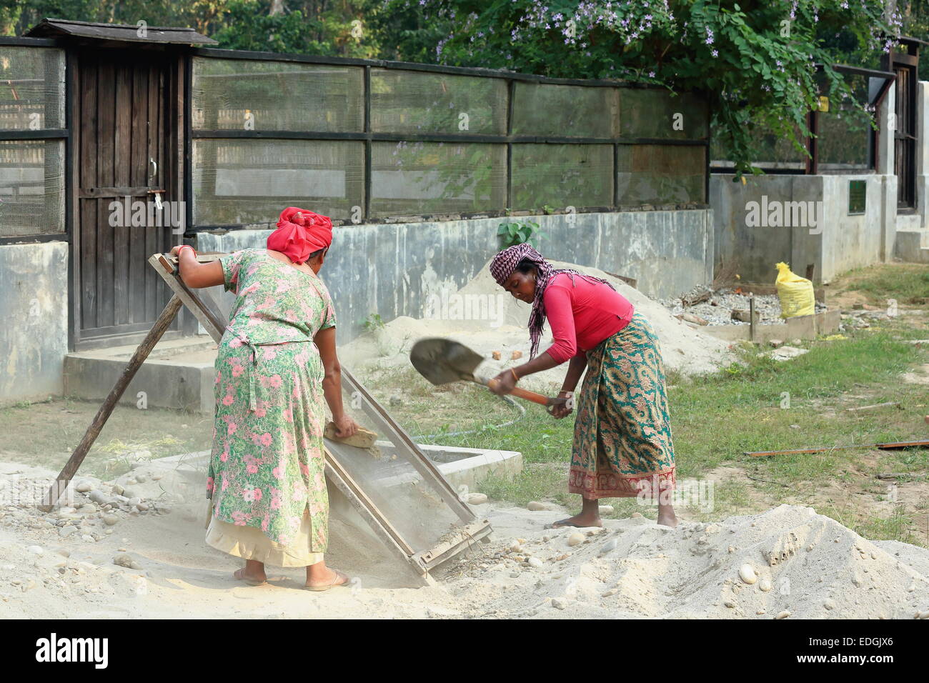CHITWAN, NEPAL - OCTOBER 14: Local women work in maintenance tasks of the Gharial Conservation Program facilities on October 14, Stock Photo