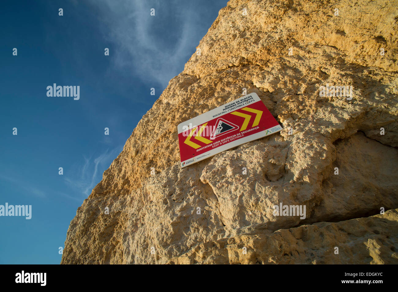 sign warning of falling rocks from a cliff face due to erosion Stock Photo