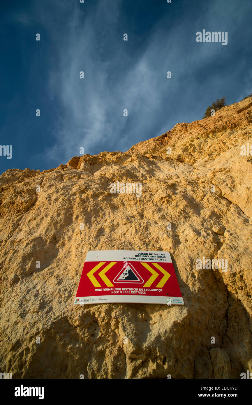 sign warning of falling rocks from a cliff face due to erosion Stock Photo