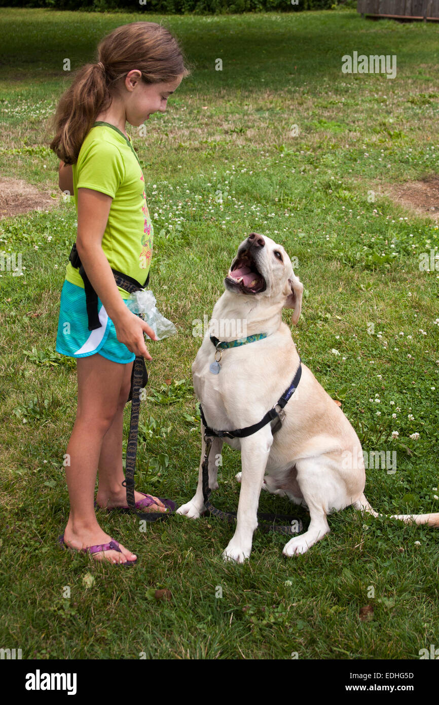 A young girl with her Labrador dog going for a walk Stock Photo - Alamy
