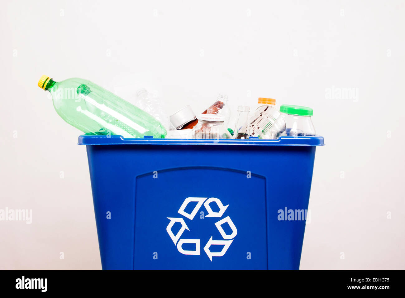 A blue recycling bin with recycled items Stock Photo Alamy