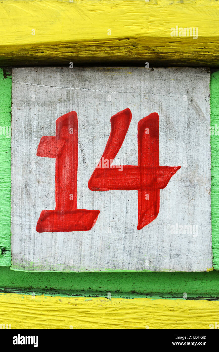 Number fourteen painted on an old painted wood board Stock Photo
