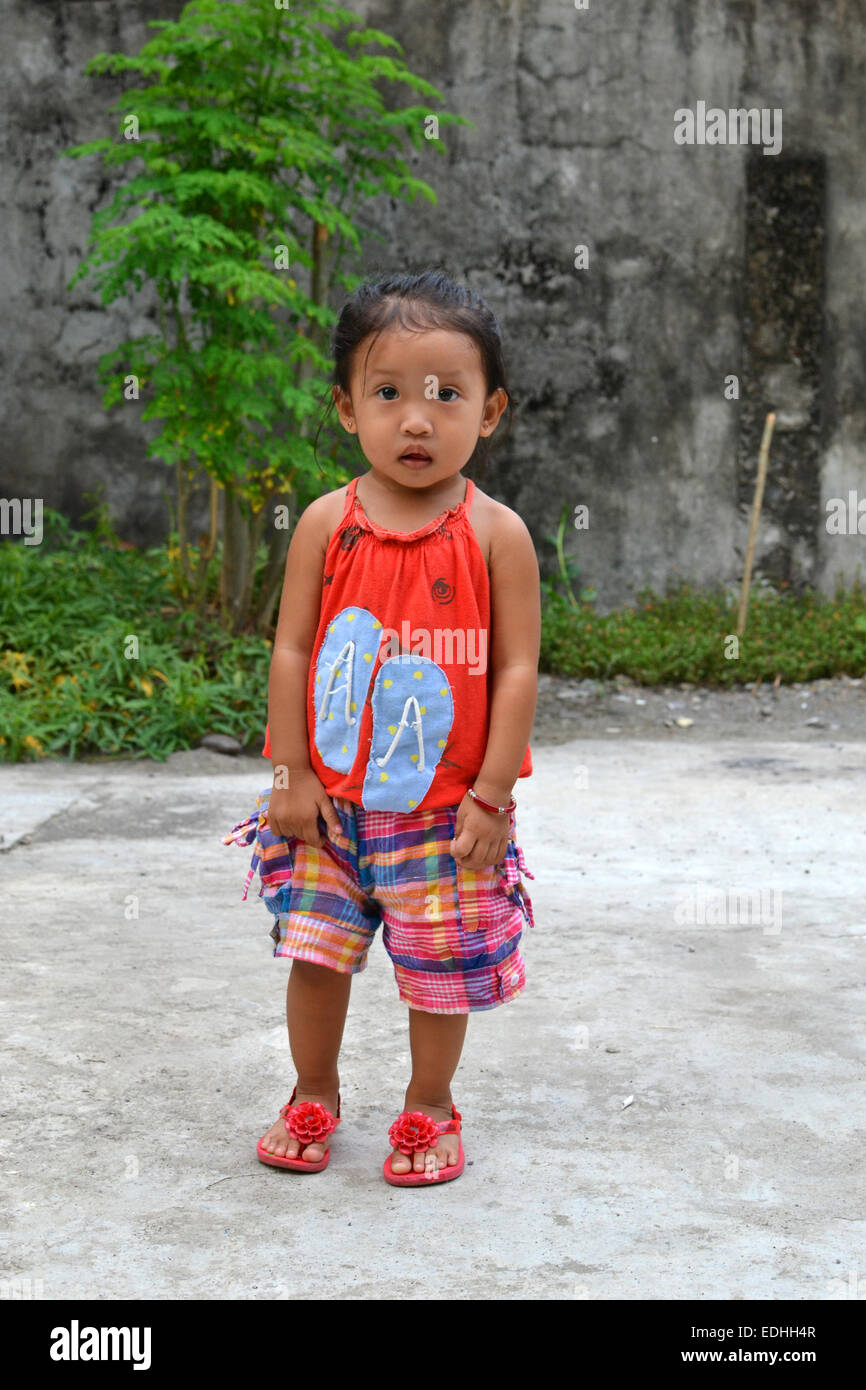 A full body portrait of beautiful asian little girl taking a step Stock Photo
