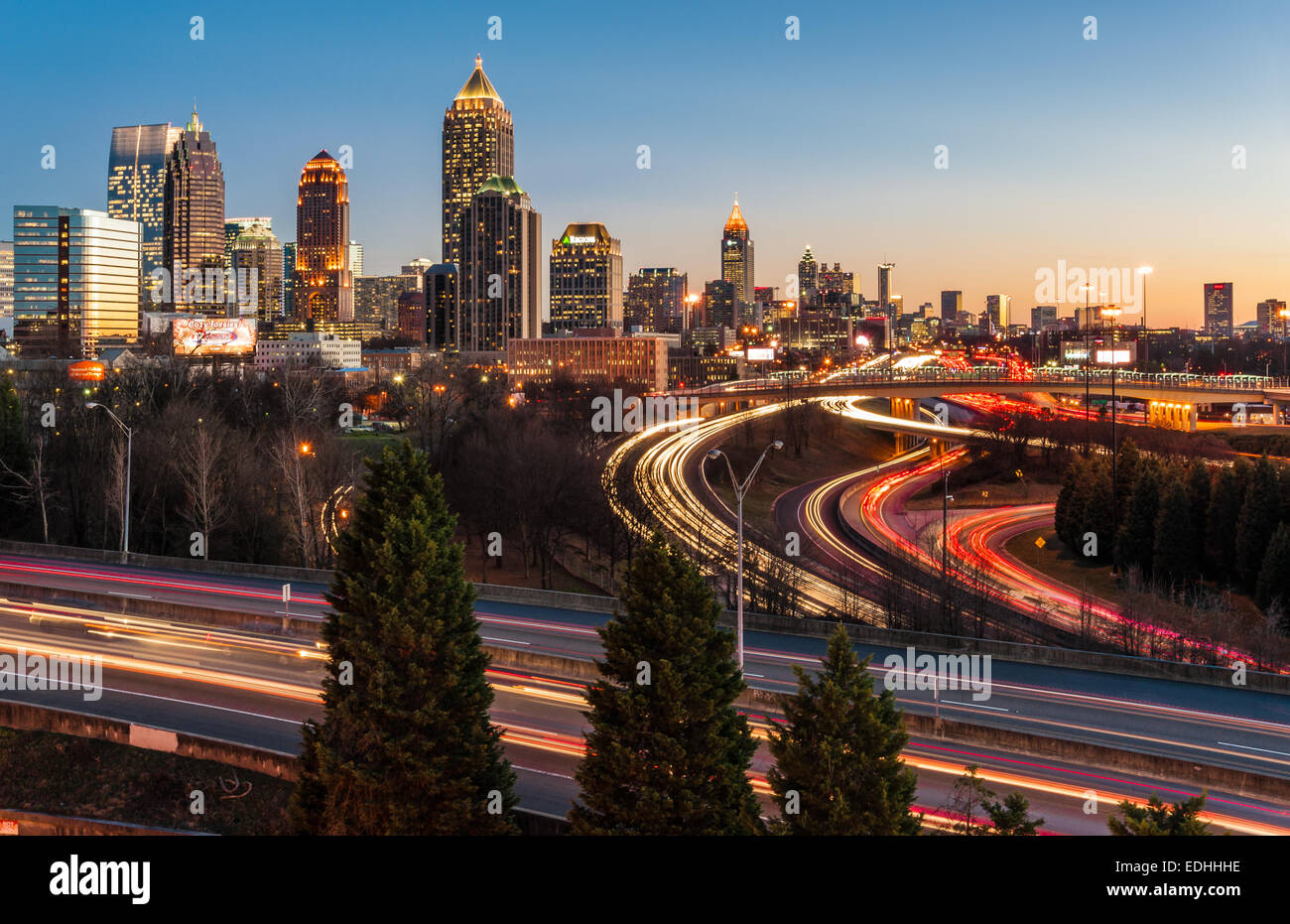 Atlanta city skyline and Interstate traffic aglow in the colors of sunset. Atlanta, Georgia, USA. Stock Photo