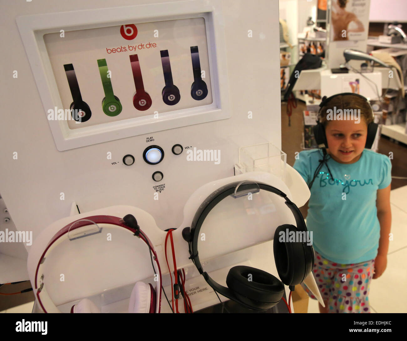 Mission Viejo, California, USA. 08th June, 2014. A young girl tries out Dr Dre headphones in a store. Beats Electronics is a division of Apple Inc. which produces audio products. The company was co-founded by rapper and hip hop producer Dr. Dre and Interscope-Geffen-A&M Records chairman Jimmy Iovine. Beats' product line is primarily focused on headphones and speakers, marketed under the brand Beats by Dr. Dre. © Ruaridh Stewart/ZUMA Wire/ZUMAPRESS.com/Alamy Live News Stock Photo