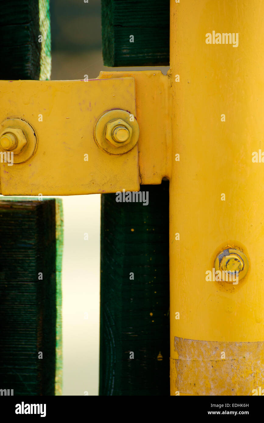 Closeup of nuts and yellow metal bar Stock Photo