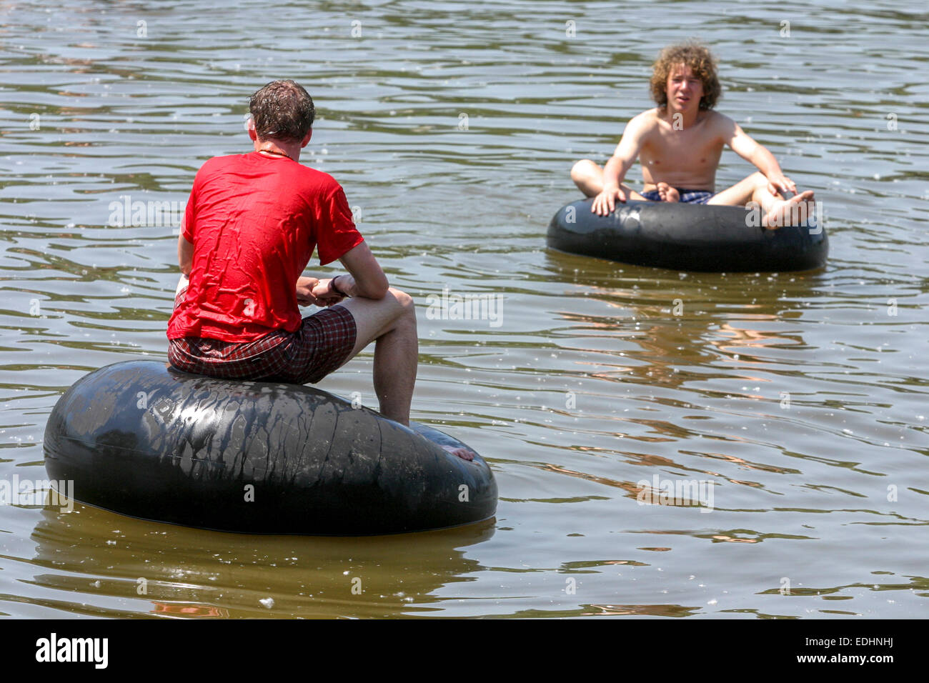 Two men on inflated rubber soul on the water Stock Photo