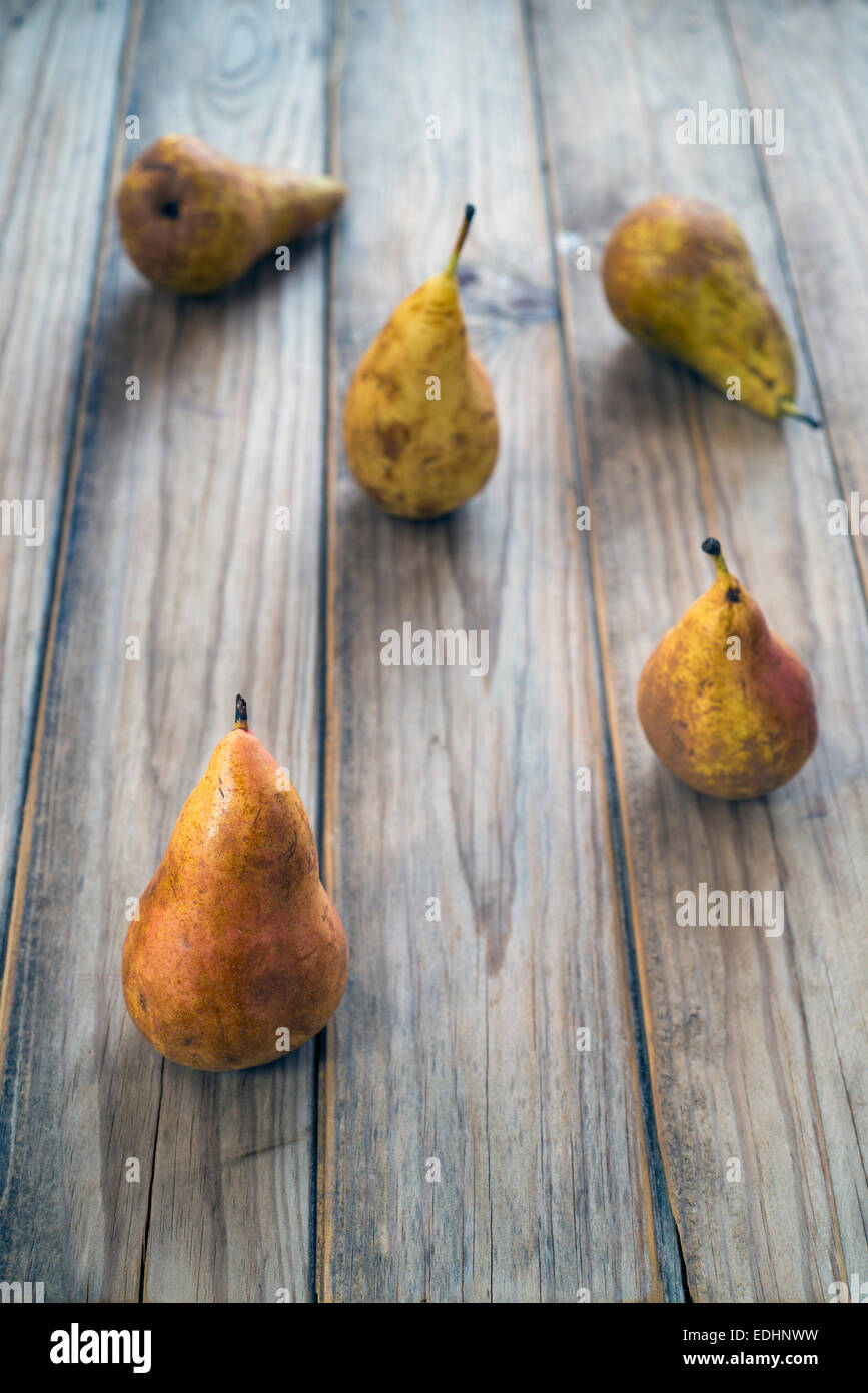 five pears on a wooden table Stock Photo - Alamy