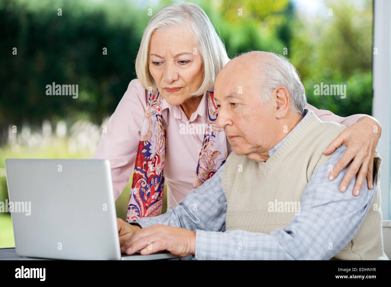 Serious Senior Man And Woman Using Laptop Stock Photo