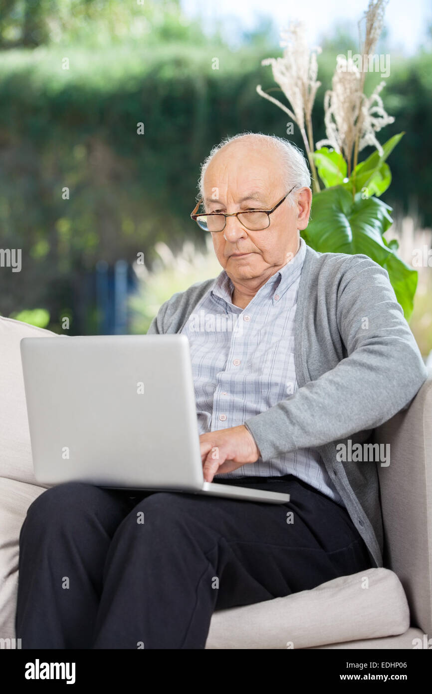 Senior Man Surfing On Laptop Stock Photo