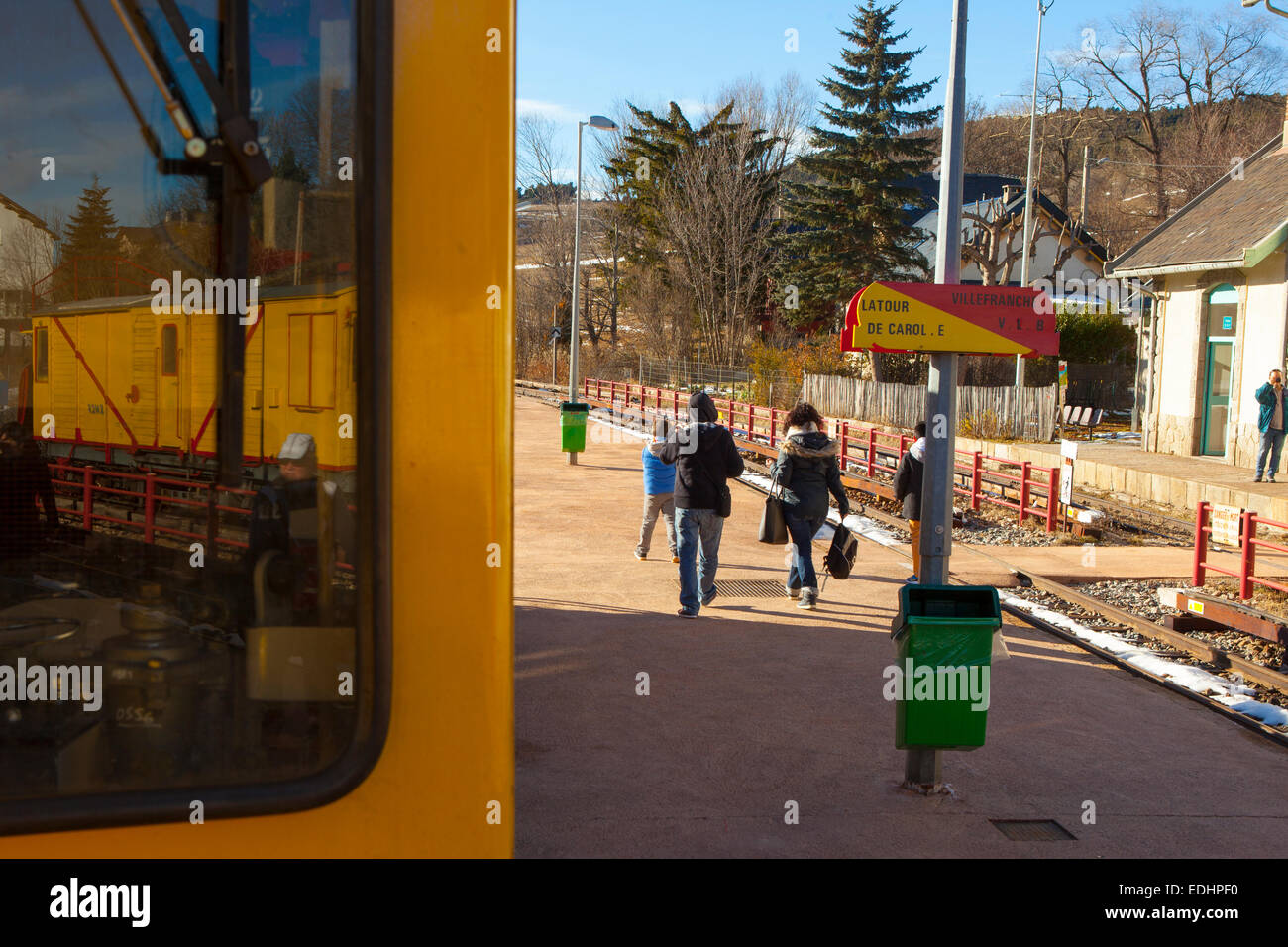 Passengers from the Train Jaune, Yellow Train, Canari, or Ligne de Cerdagne, at the Mont-Louis - La Cabanasse station. Stock Photo