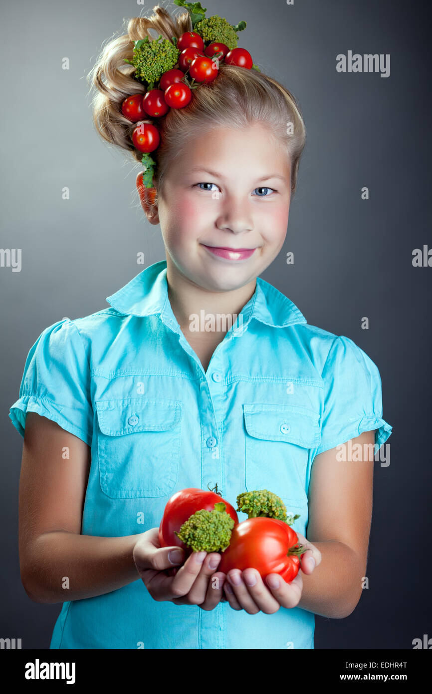 Smiling girl posing with wreath of cherry tomatoes Stock Photo - Alamy