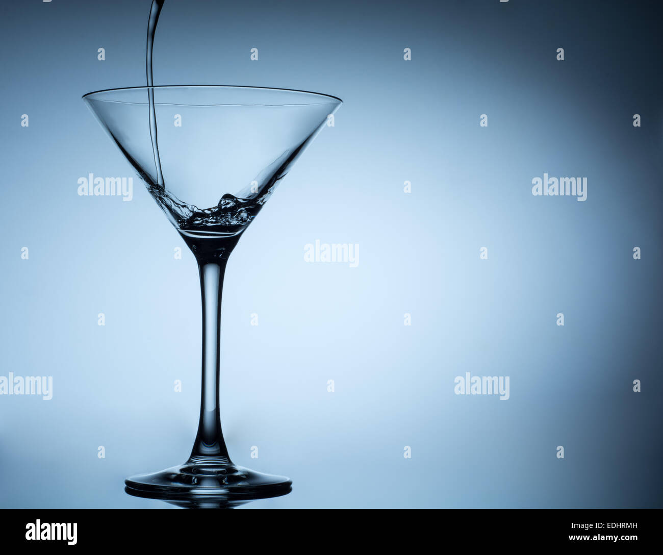 cocktail pouring in martini glasses Stock Photo Alamy