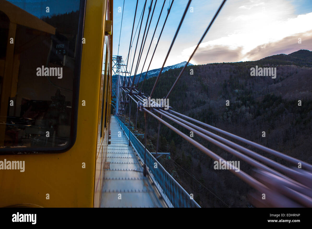 The Train Jaune, Yellow Train, Canari, or Ligne de Cerdagne, crossing the Pont Gisclard suspension bridge. Stock Photo