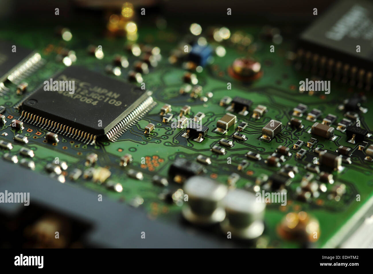 Micro-circuitry from a computer. The integrated circuit board has microchips.. Stock Photo