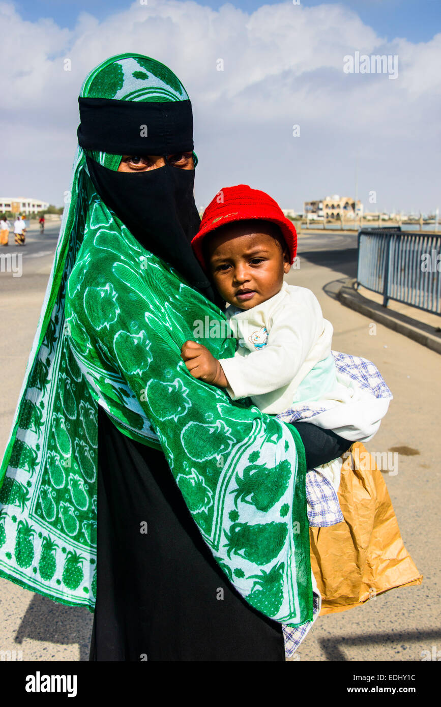 Fully veiled Muslim woman and her child, Massawa, Eritrea Stock Photo