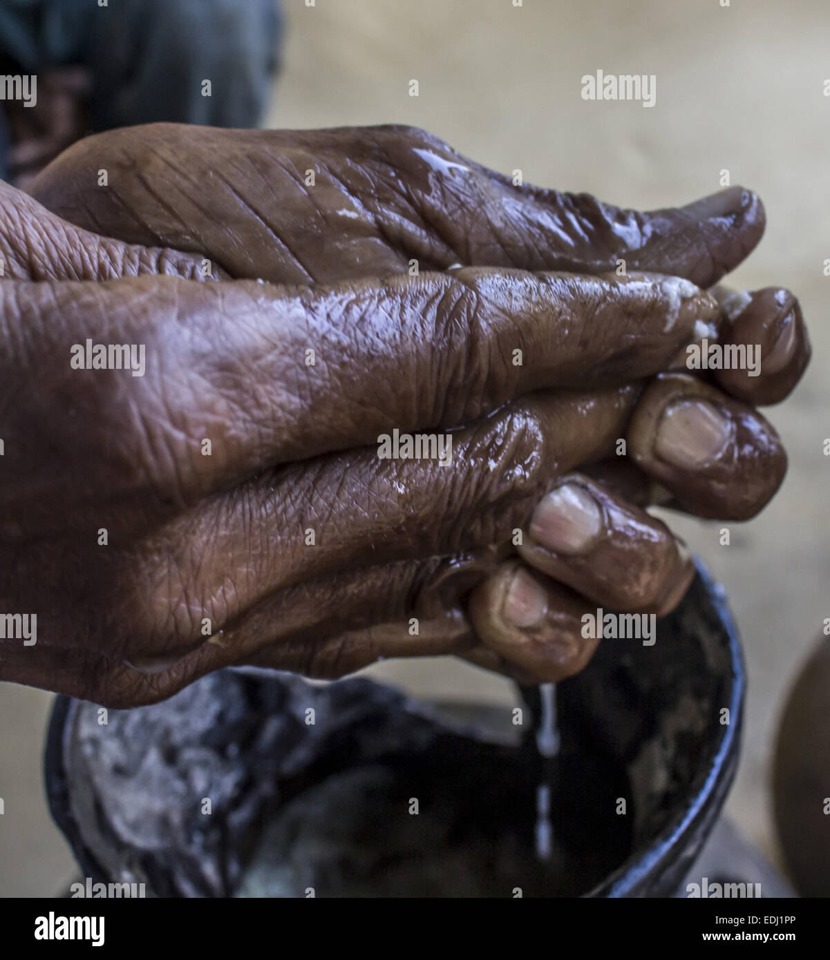 Sivasagar, Assam, India. 7th Jan, 2015. An elderly Ahom tribal woman prepares 'Saaj-Pani' (Rice Beer) using the indigenous method at her house ahead of Bhogali Bihu - The festival of feast, at a village in Sivasagar district of northeastern Assam state on January 7, 2015. Rice beer is a delicacy among all the tribal communities inhabiting northeast India and almost each and every household prepares their own rice beer for their daily consumption. © Luit Chaliha/ZUMA Wire/ZUMAPRESS.com/Alamy Live News Stock Photo