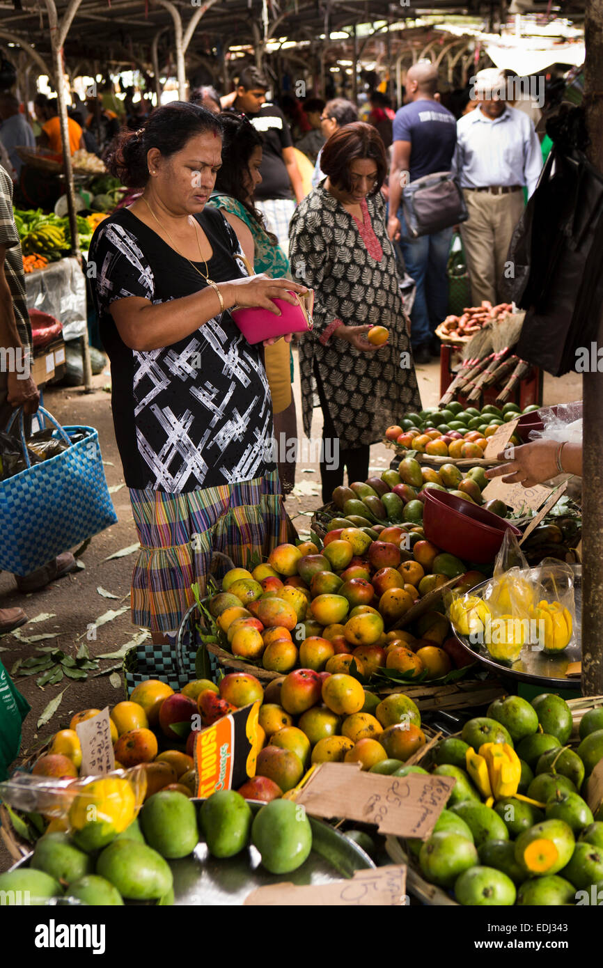 Mauritius, Quatre Bornes, Market, female shopper looking in purse for