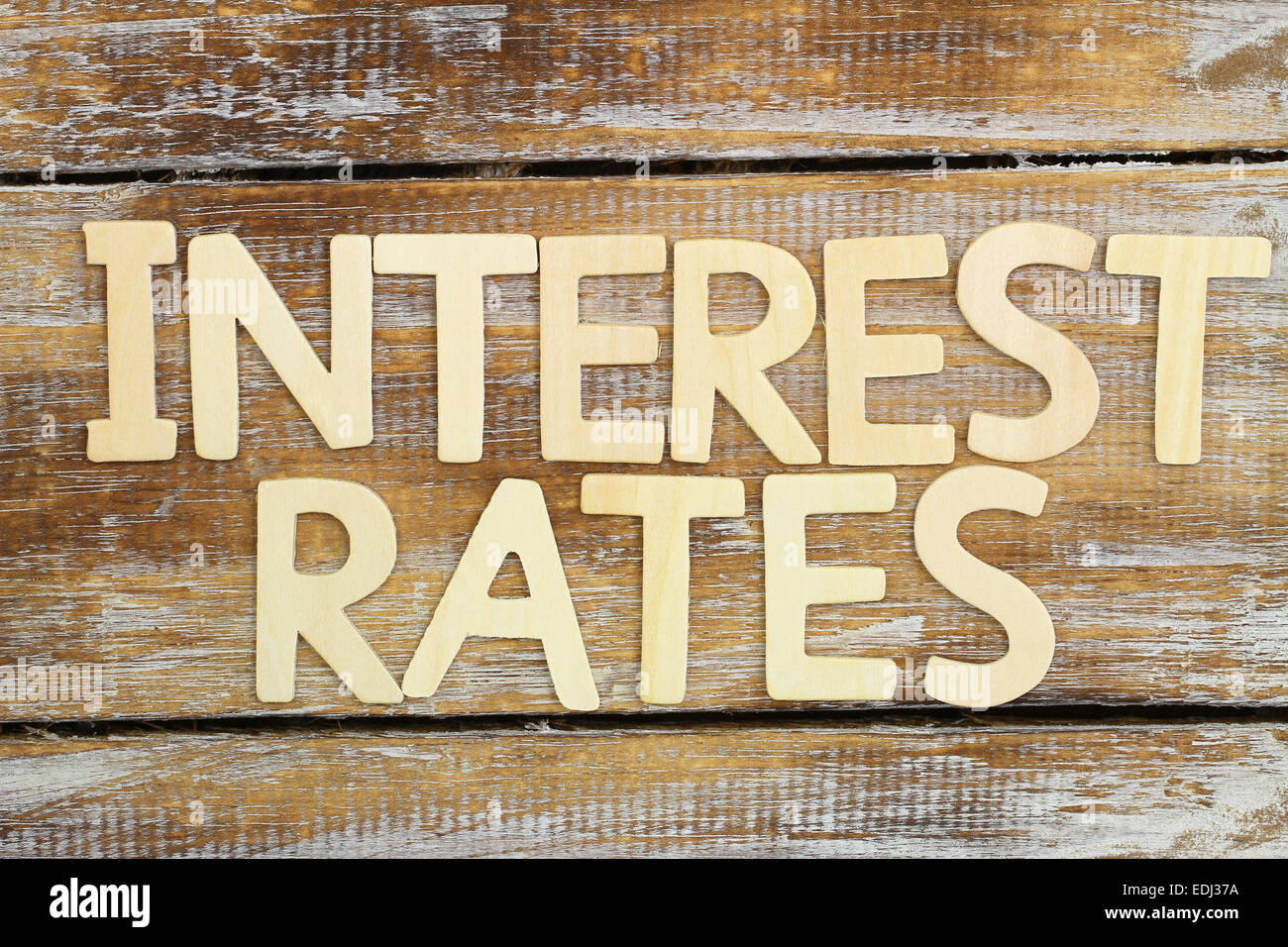 Interest rates written with wooden letters on rustic wooden surface Stock Photo