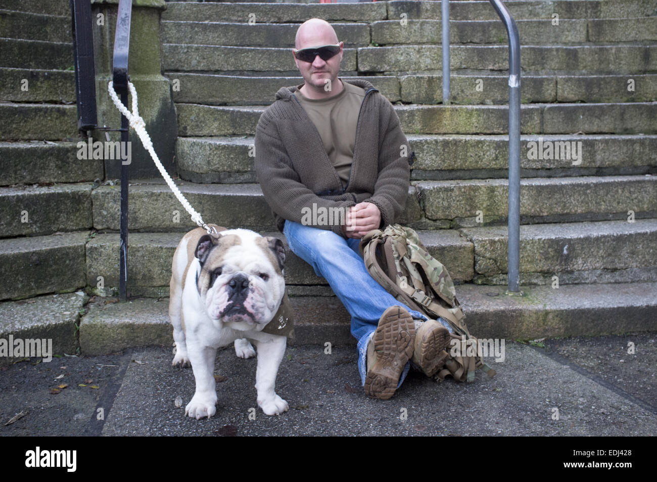 A man with his bulldog in Falmouth, UK Stock Photo