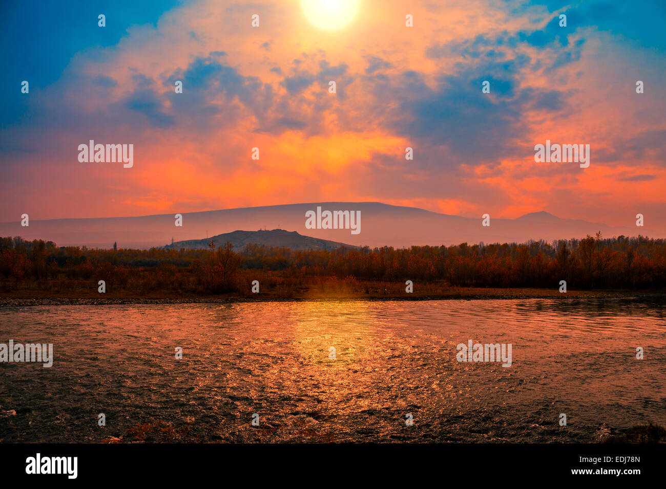 Foggy sunset over mountain river Stock Photo