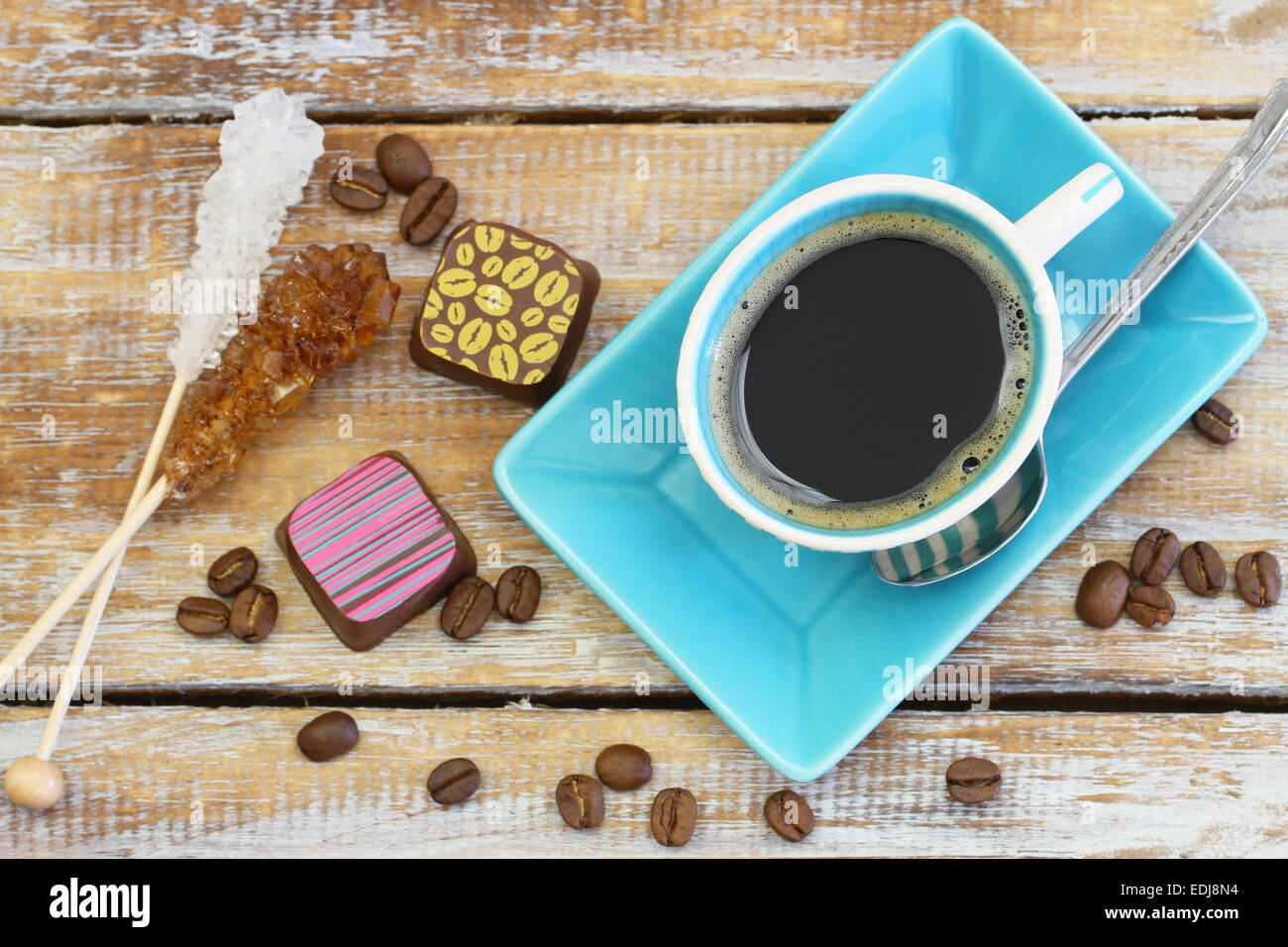Coffee, sugar sticks and chocolates on rustic wooden surface Stock Photo Alamy