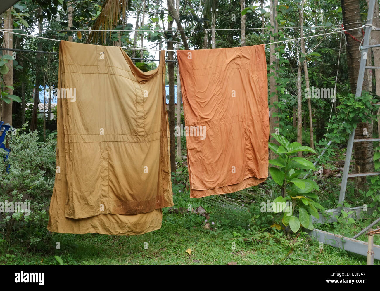 Two monk's robes drying, Lanta Old Town Buddhist temple, forest monastery, Koh Lanta Thailand, Southeast Asia. Stock Photo