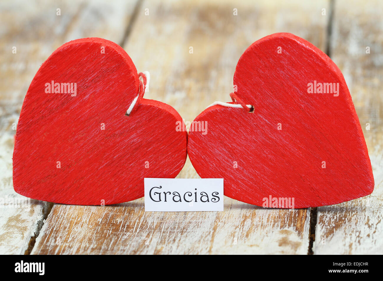 Gracias (which means thank you in Spanish) with two red wooden hearts