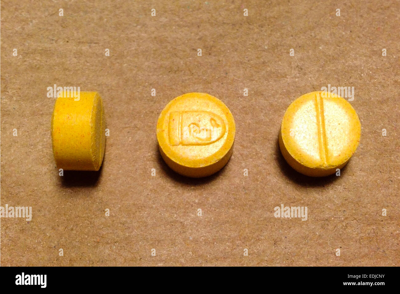 Ecstasy pills called  'Yellow Mario Bullet' containing between 150-200mg of MDMA (3,4-methylenedioxy-N-methylamphetamine). Stock Photo