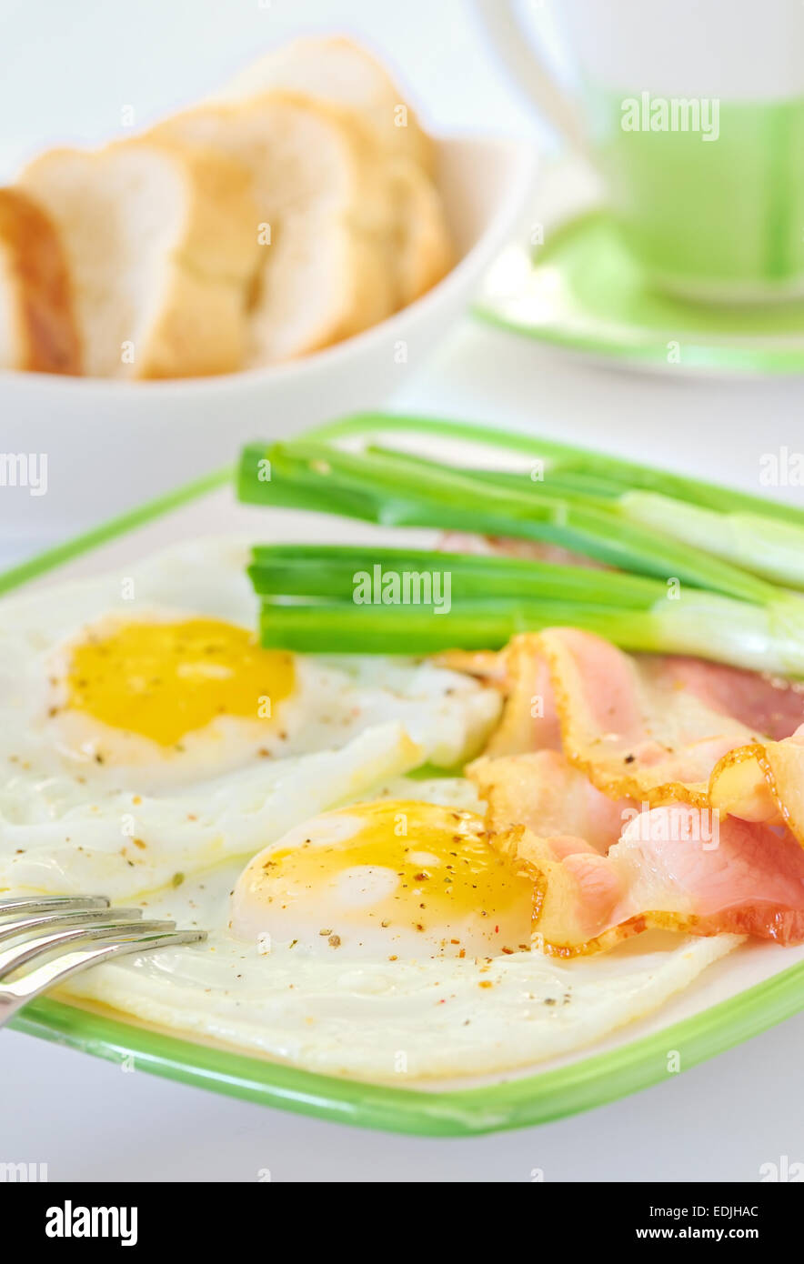 Traditional breakfast with bacon and fried eggs Stock Photo