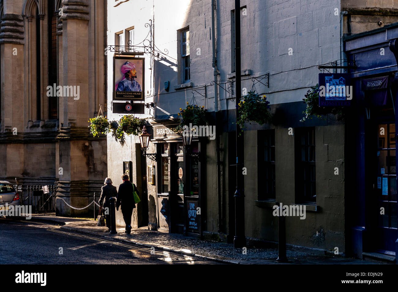 Architecture in Bath Somerset on Walcot Street with Saracens Head Tavern illuminated by winter sunlight Stock Photo