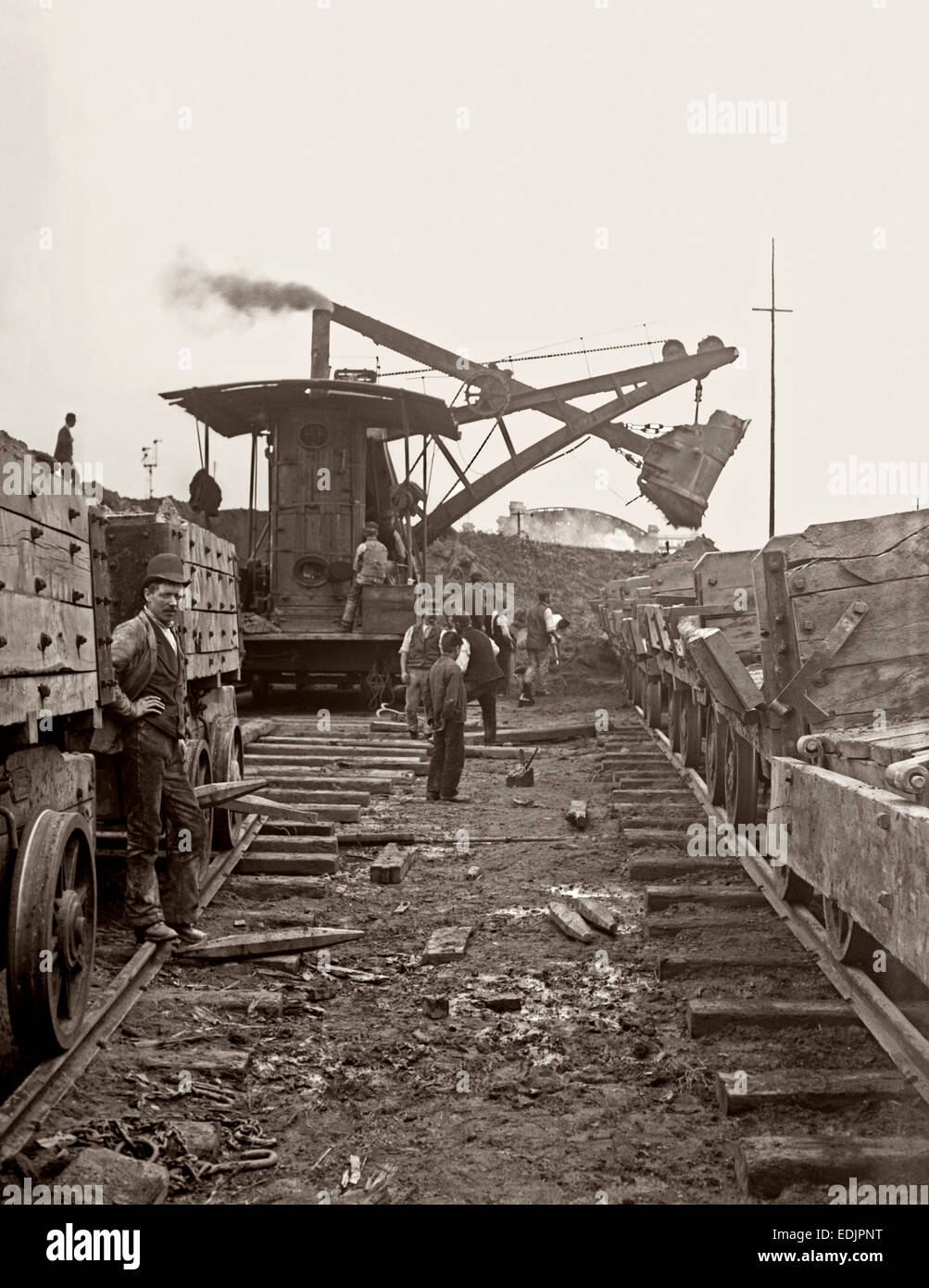 Navvies (construction workers) building the Manchester Ship Canal load waggons using a steam digger ('steam navvy') c. 1890 Stock Photo