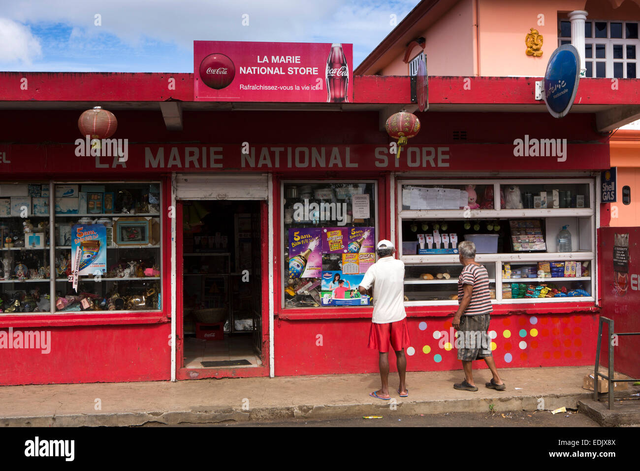 Mauritius, Vacoas, men outside La Marie National Store, red painted rural shop Stock Photo