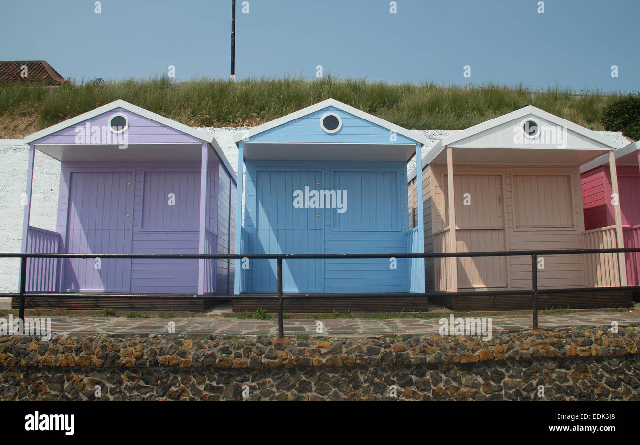 Beach huts painted in pastel colours overlooking beach, Clacton-on-Sea Stock Photo