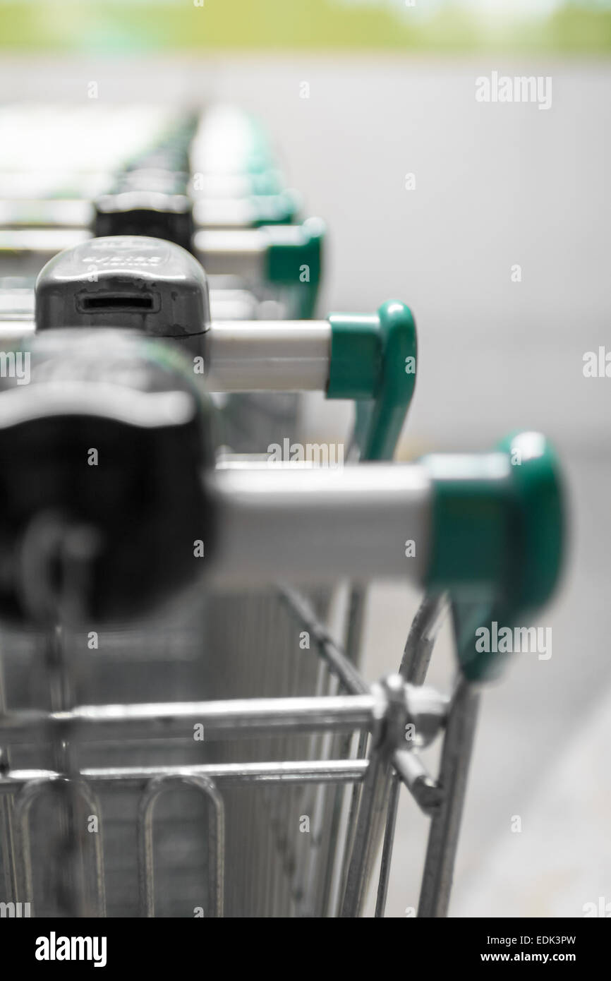Green shopping carts in the parking lot of a supermarket Stock Photo
