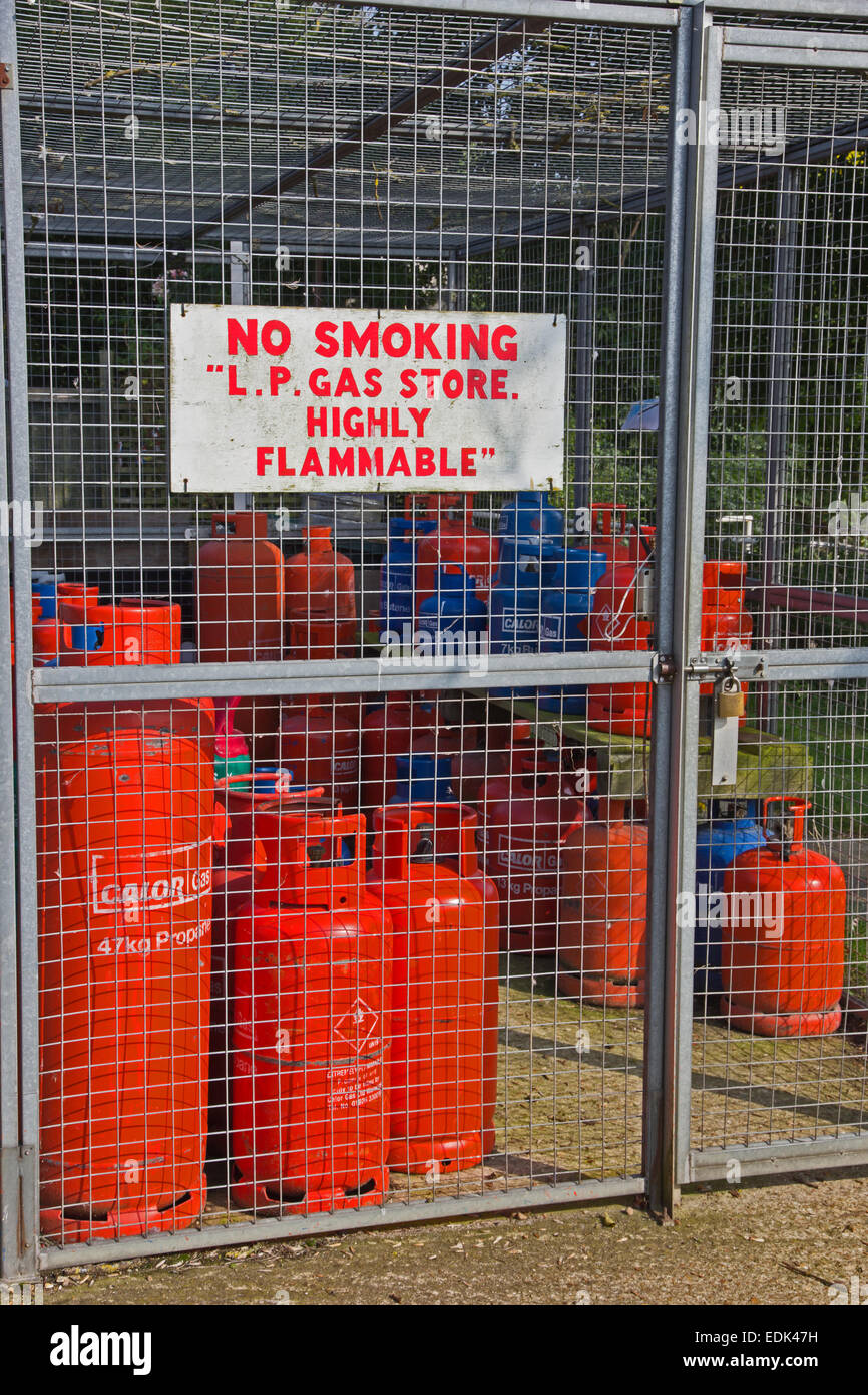 Bottles of butane and propane gas stored in security cage. Stock Photo
