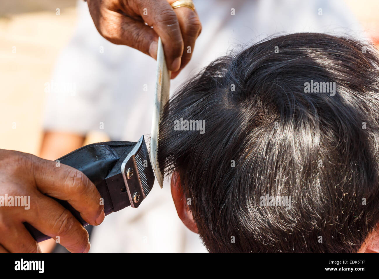 man is cutting hill-man's hair in thailand Stock Photo