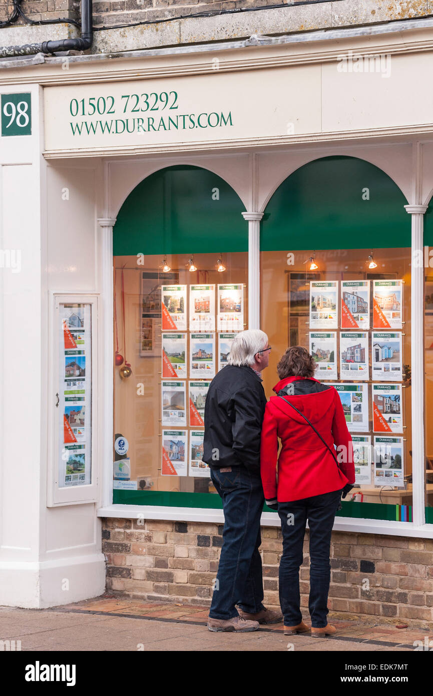 People looking in the window of Durrants Estate Agent at Southwold